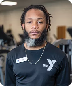 A photo of Javon Johnson, personal trainer at the Reidsville YMCA. He is smiling at the camera.