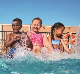 A group of children at the edge of a pool during a Safety Around Water class.